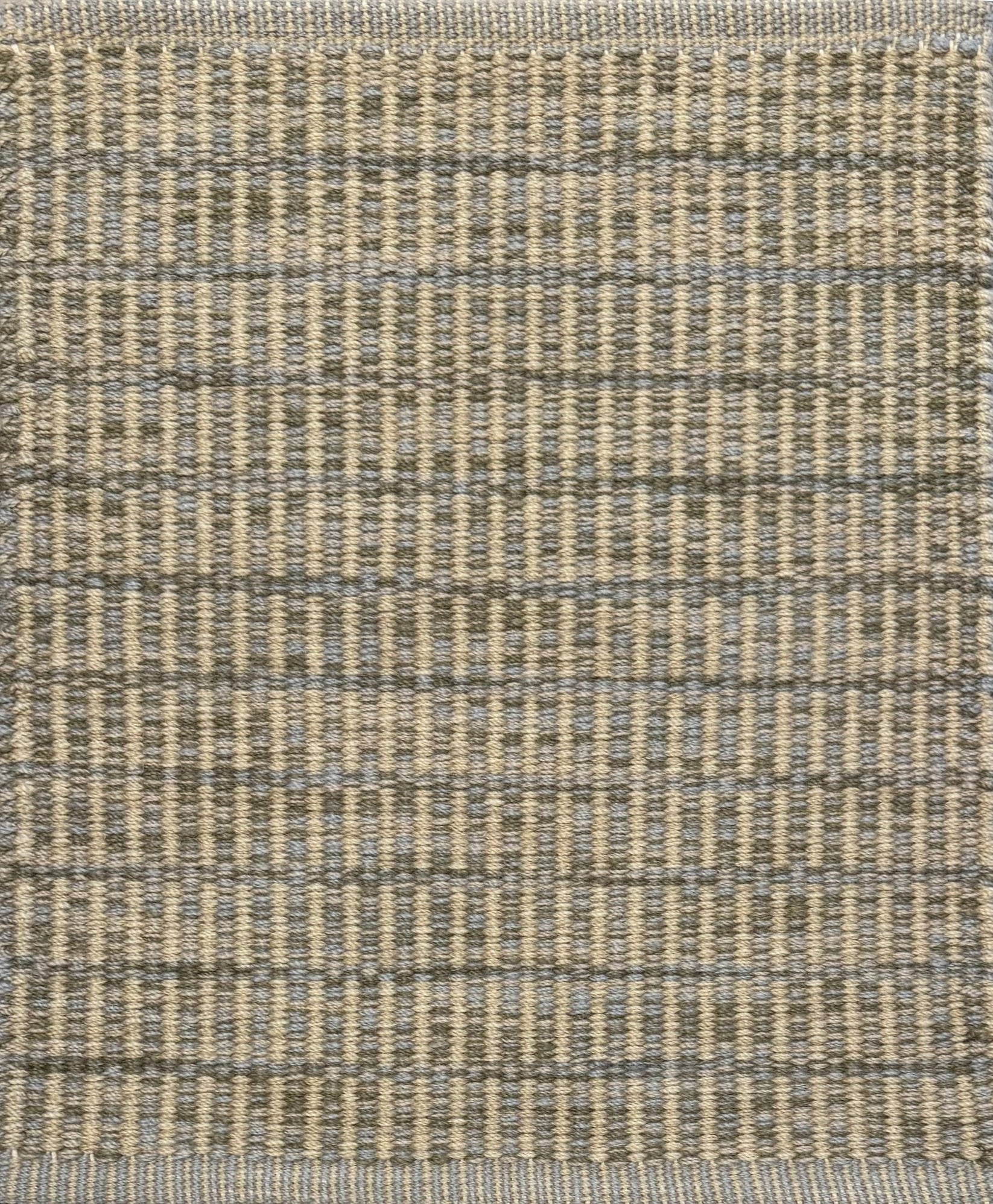 Textured rug with a grey and beige checker pattern