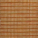 Textured rug with an orange and beige  checker pattern