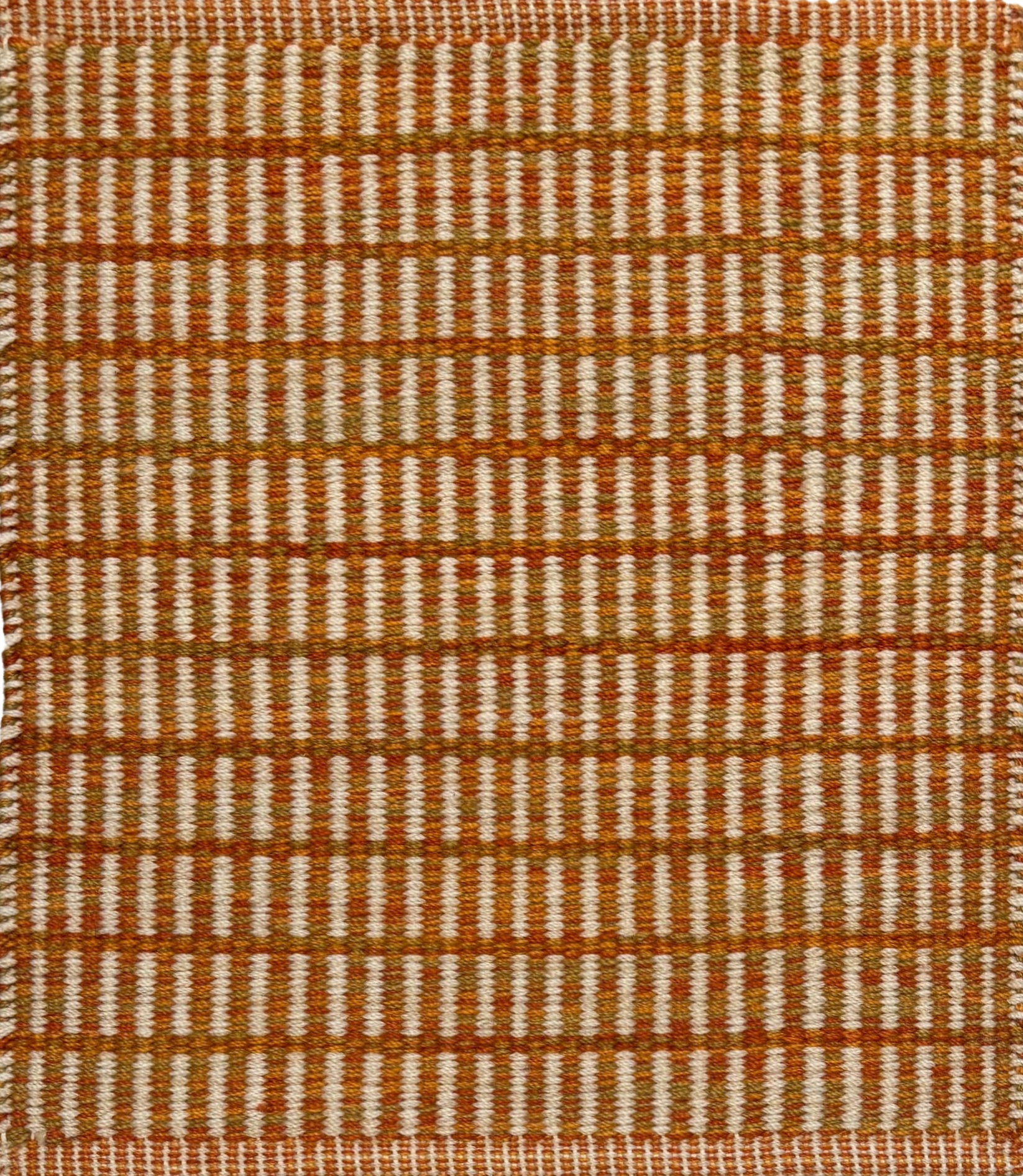 Textured rug with an orange and beige  checker pattern