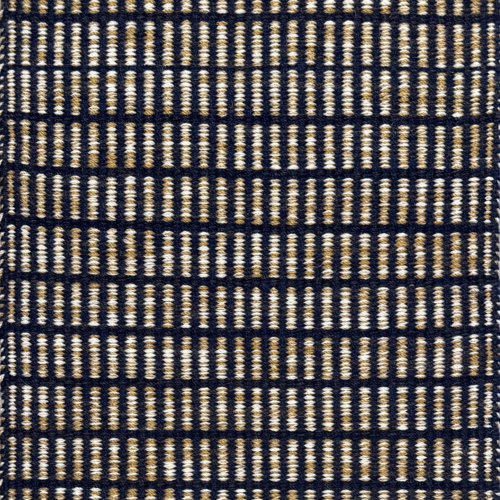 Textured rug with a black and beige  checker pattern