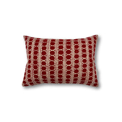 Rectangular throw pillow with a striped pattern made of circles and dashed lines in brick red on a natural linen background.