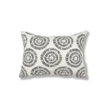 Rectangular throw pillow in a circular dot pattern made of small dashed lines in grey printed on white linen.