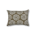 Rectangular throw pillow in a circulart dot pattern made of small dashed lines in white printed on natural linen.