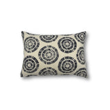 Rectangular throw pillow in a circulart dot pattern made of small dashed lines in navy blue printed on cream linen.