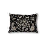 Rectangular throw pillow with a tree at center framed with symetrical lion figures, the back ground is a solid black, the motif is a natural linen color. 