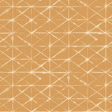 Detail of fabric in a mottled lattice print in white on a burnt orange field.