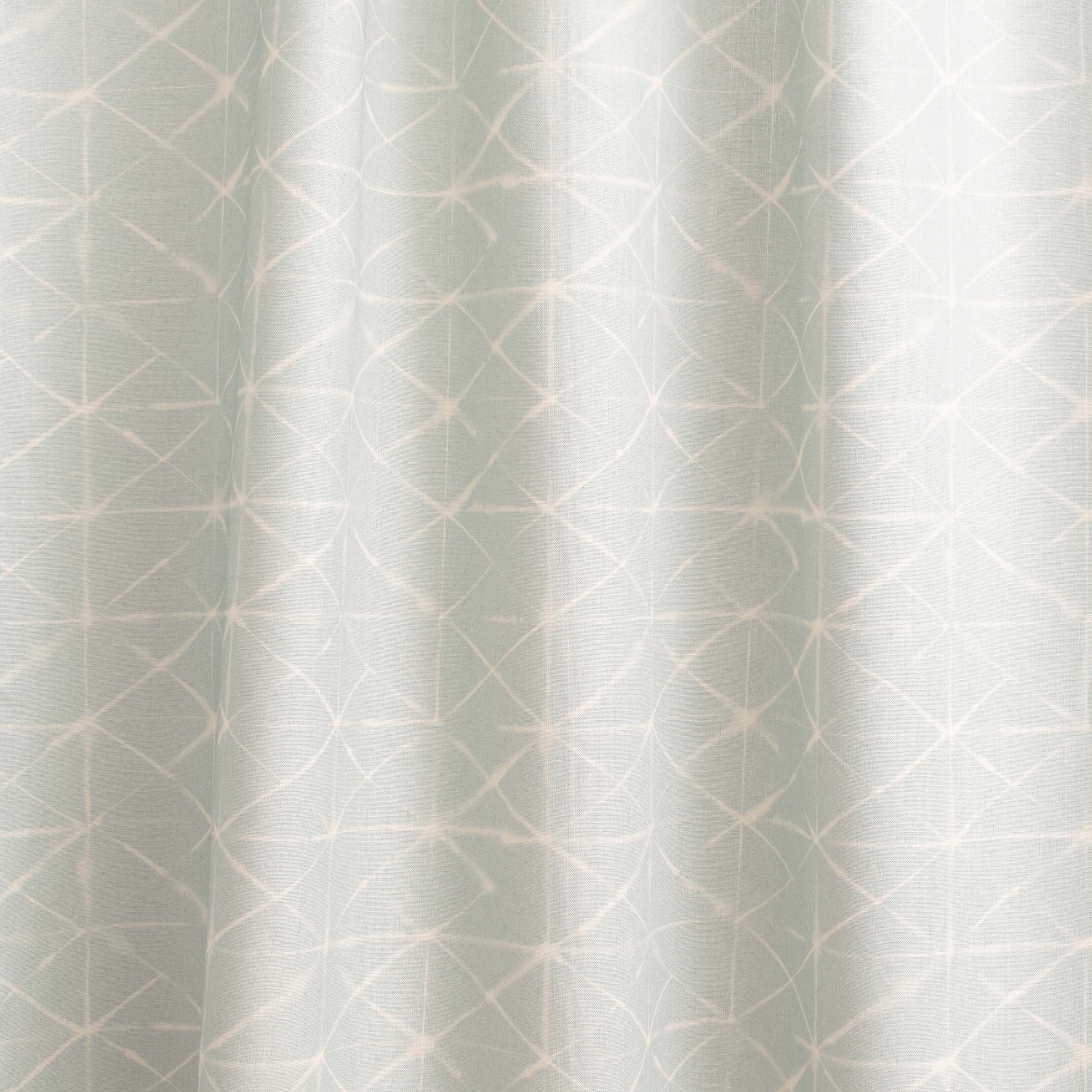 Draped fabric yardage in a mottled lattice print in white on a light blue field.