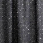 Draped fabric yardage in a mottled lattice print in white on a black field.