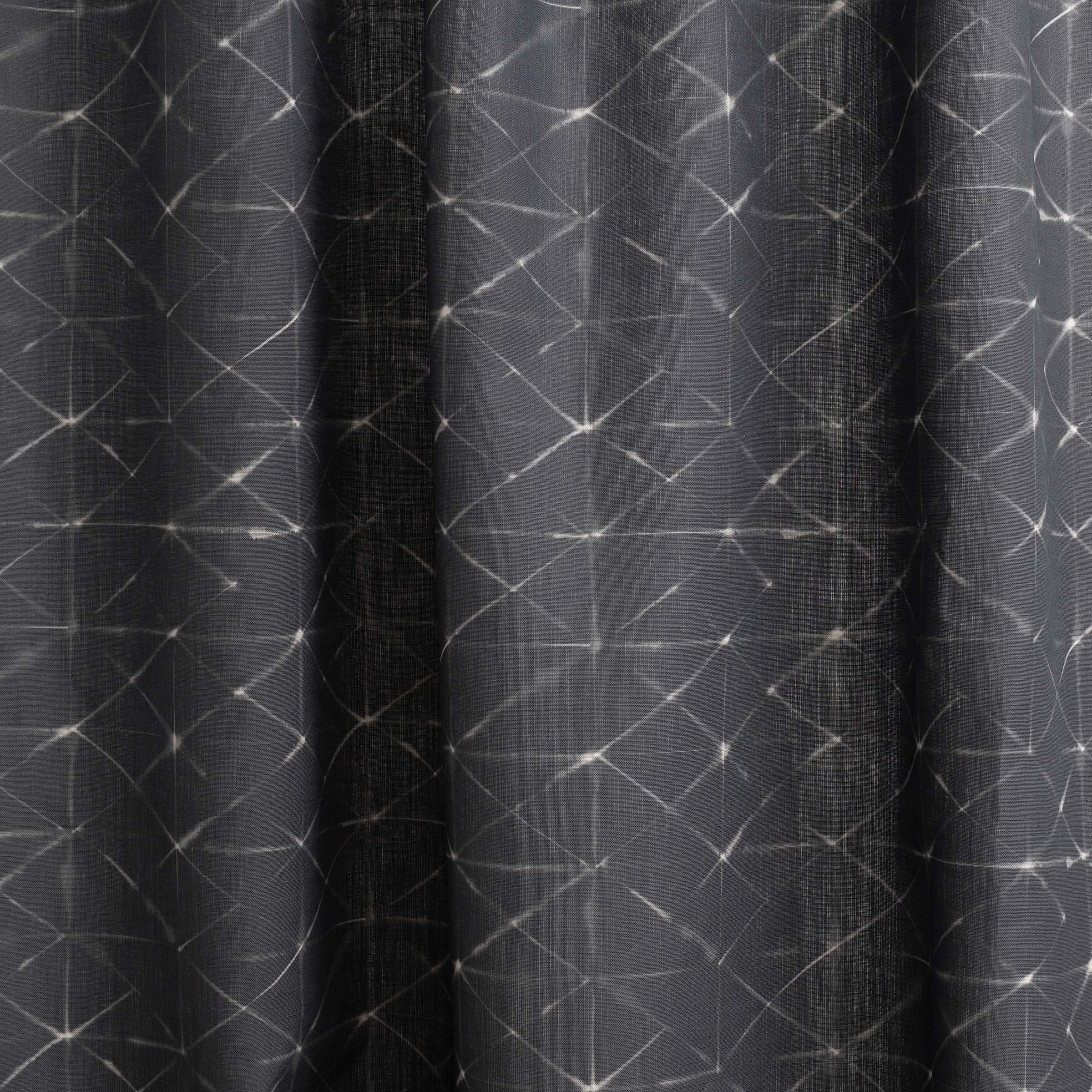 Draped fabric yardage in a mottled lattice print in white on a black field.