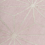 Detail of a geometric patterned carpet with silver lattice design on a light purple background
