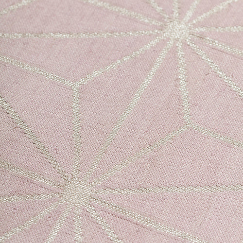 Detail of a geometric patterned carpet with silver lattice design on a light purple background