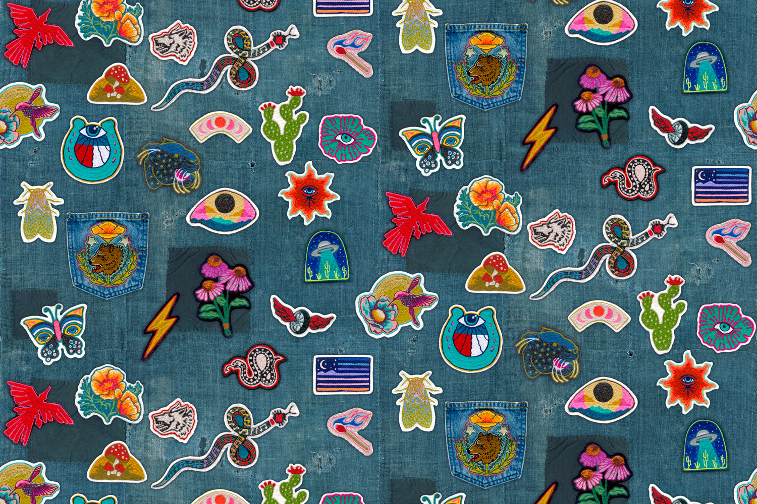 Collection of colorful embroidered patches on a denim fabric background