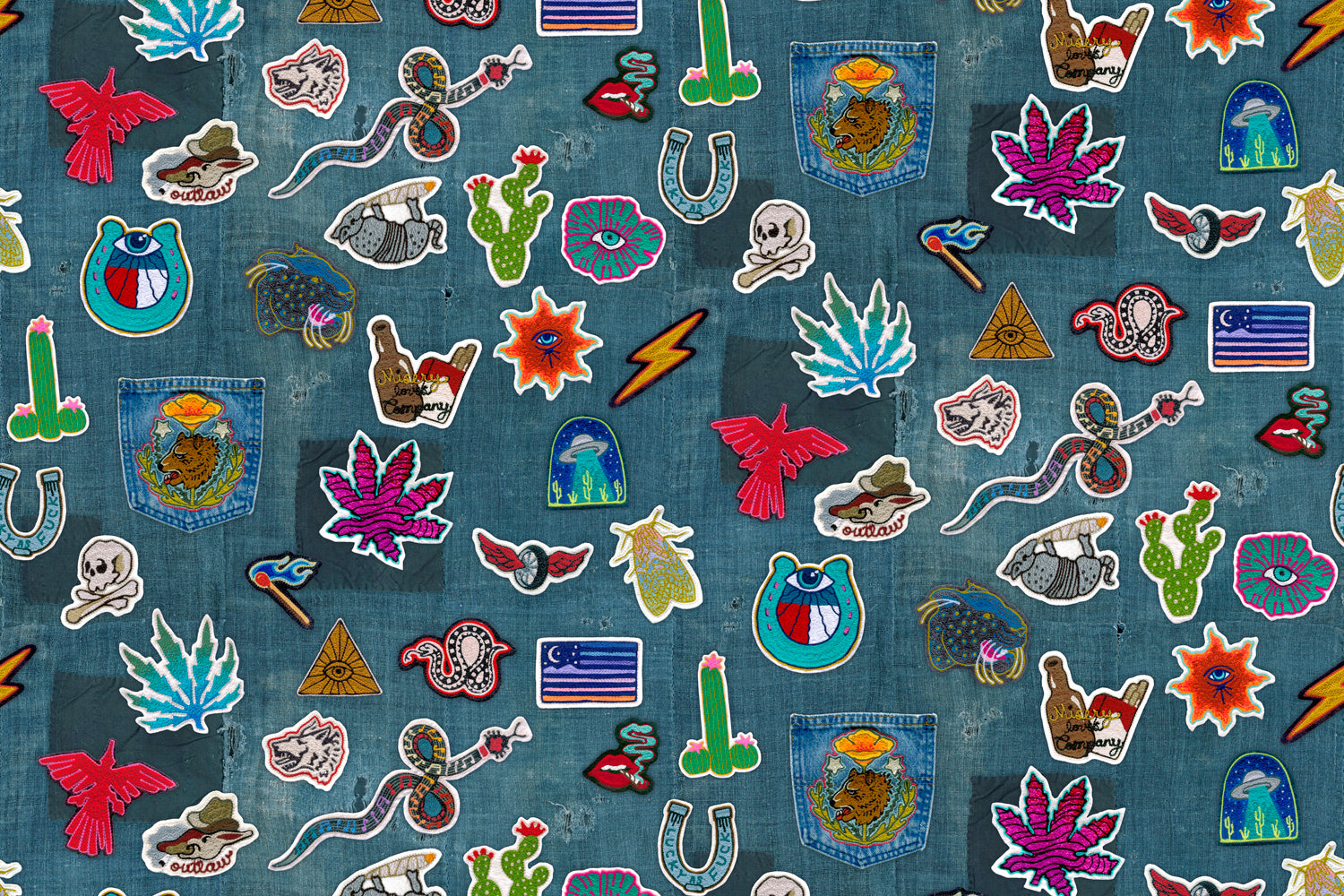 Collection of colorful embroidered patches on a denim fabric background