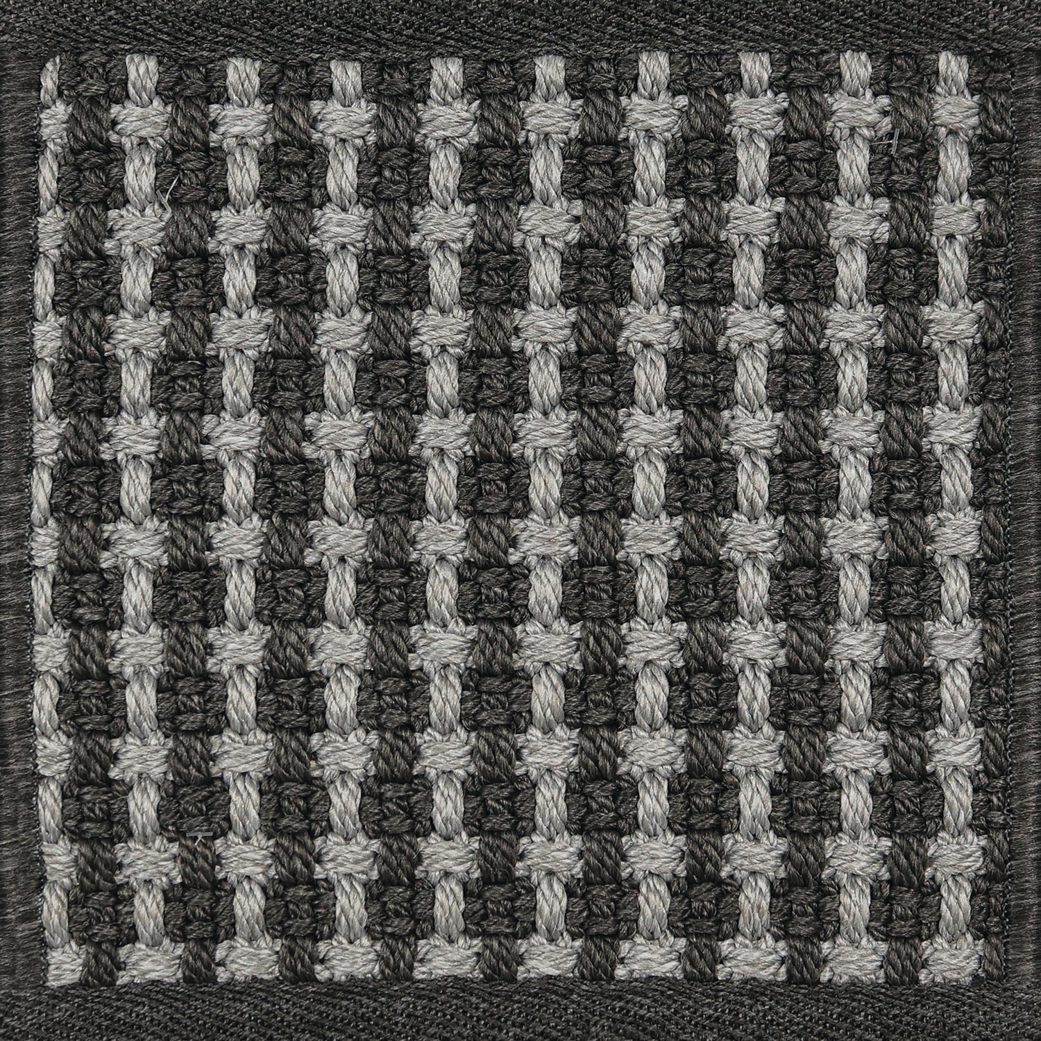 Textured woven outdoor carpet a basketweave design in black and grey.