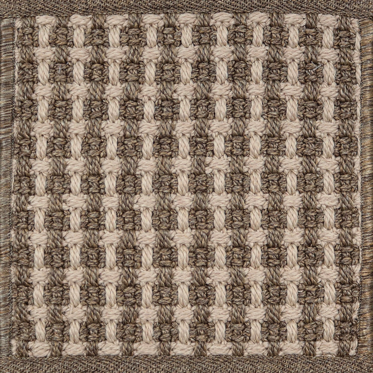 Textured woven outdoor carpet a basketweave design in shades of brown.