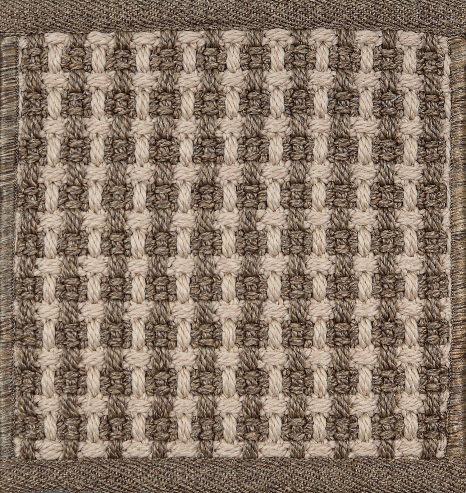 Textured woven outdoor carpet a basketweave design in shades of brown.
