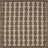 Textured woven outdoor carpet a basketweave design in shades of brown.