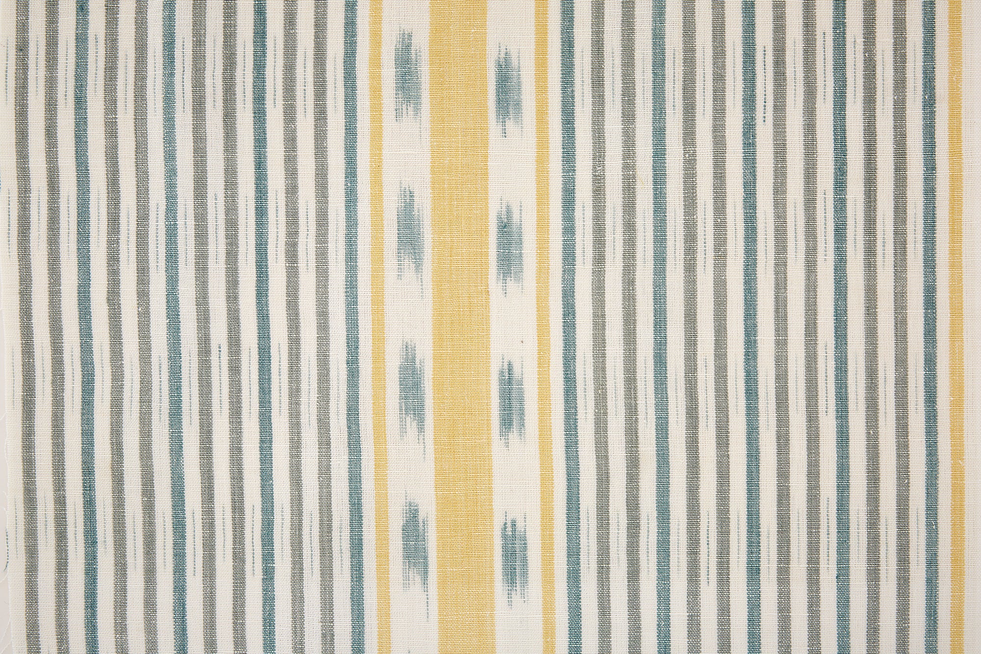 Detail of fabric in a global stripe print in blue, gray and yellow on a white field.