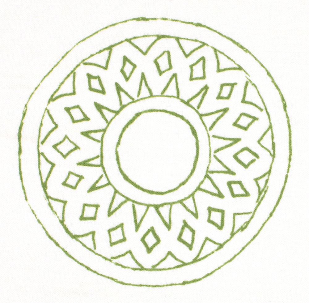 Detail of fabric in a repeating circular geometric print in green on a white field.