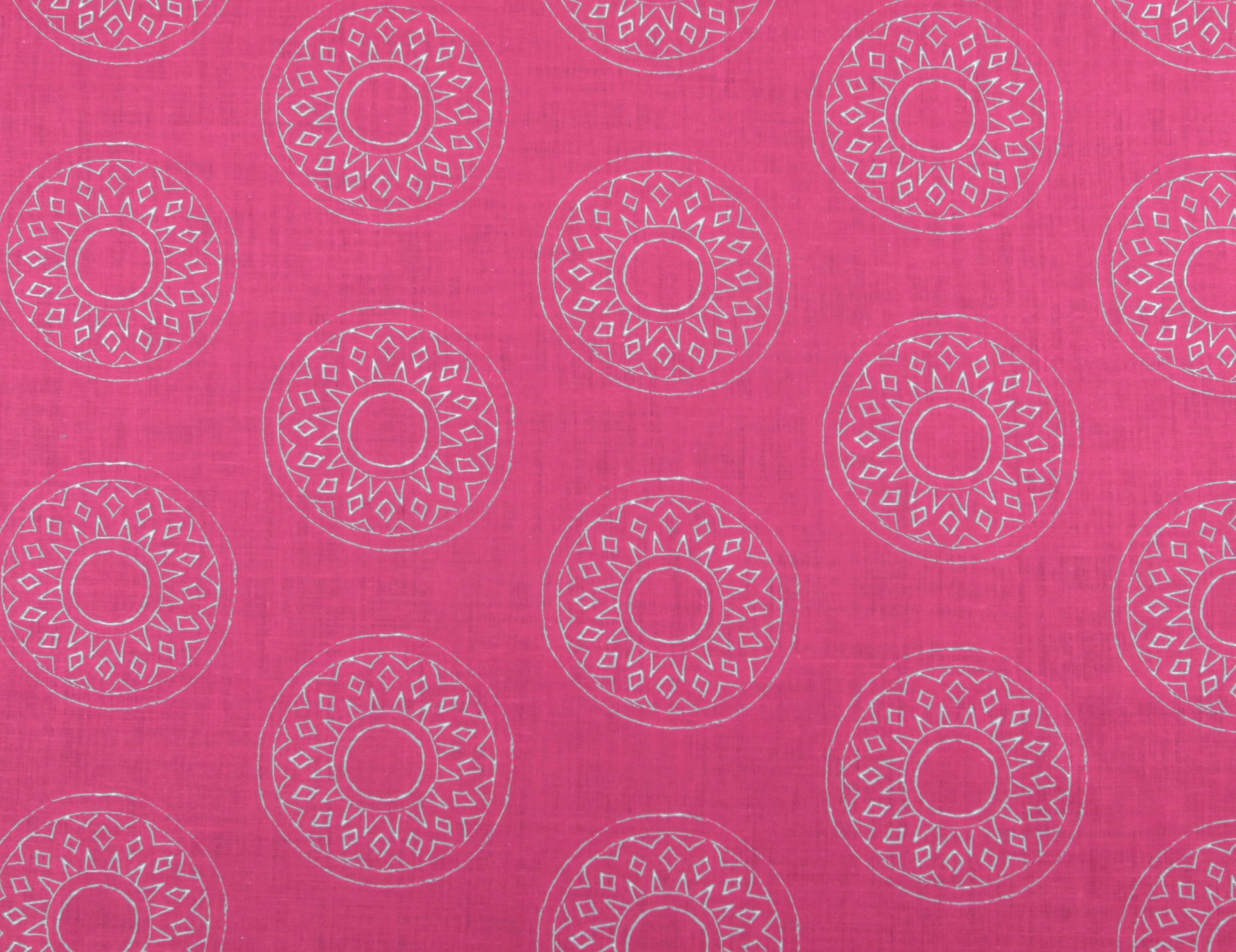 Detail of fabric in a repeating circular geometric print in light gray on a fuchsia field.