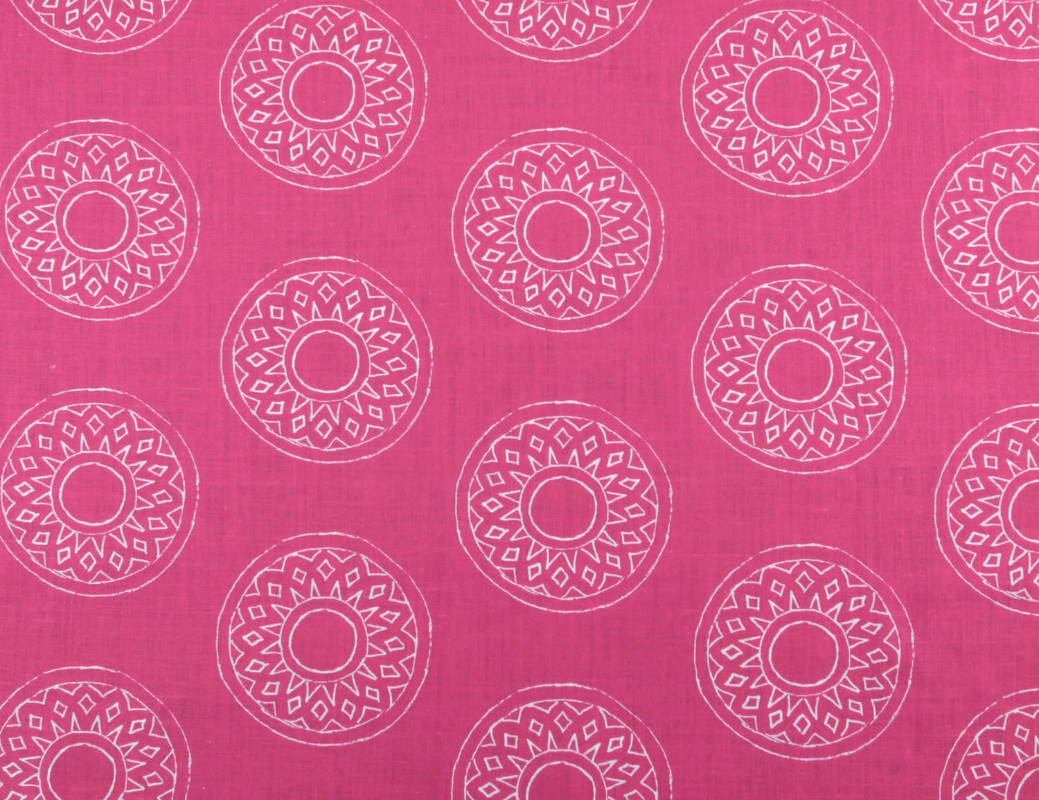 Detail of fabric in a repeating circular geometric print in white on a fuchsia field.