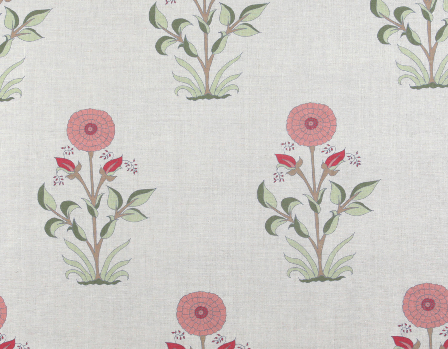 Detail of fabric in a large-scale marigold print in coral, red and green on a white field.