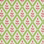 Detail of fabric in a lattice and leaf print in maroon and green on a white field.