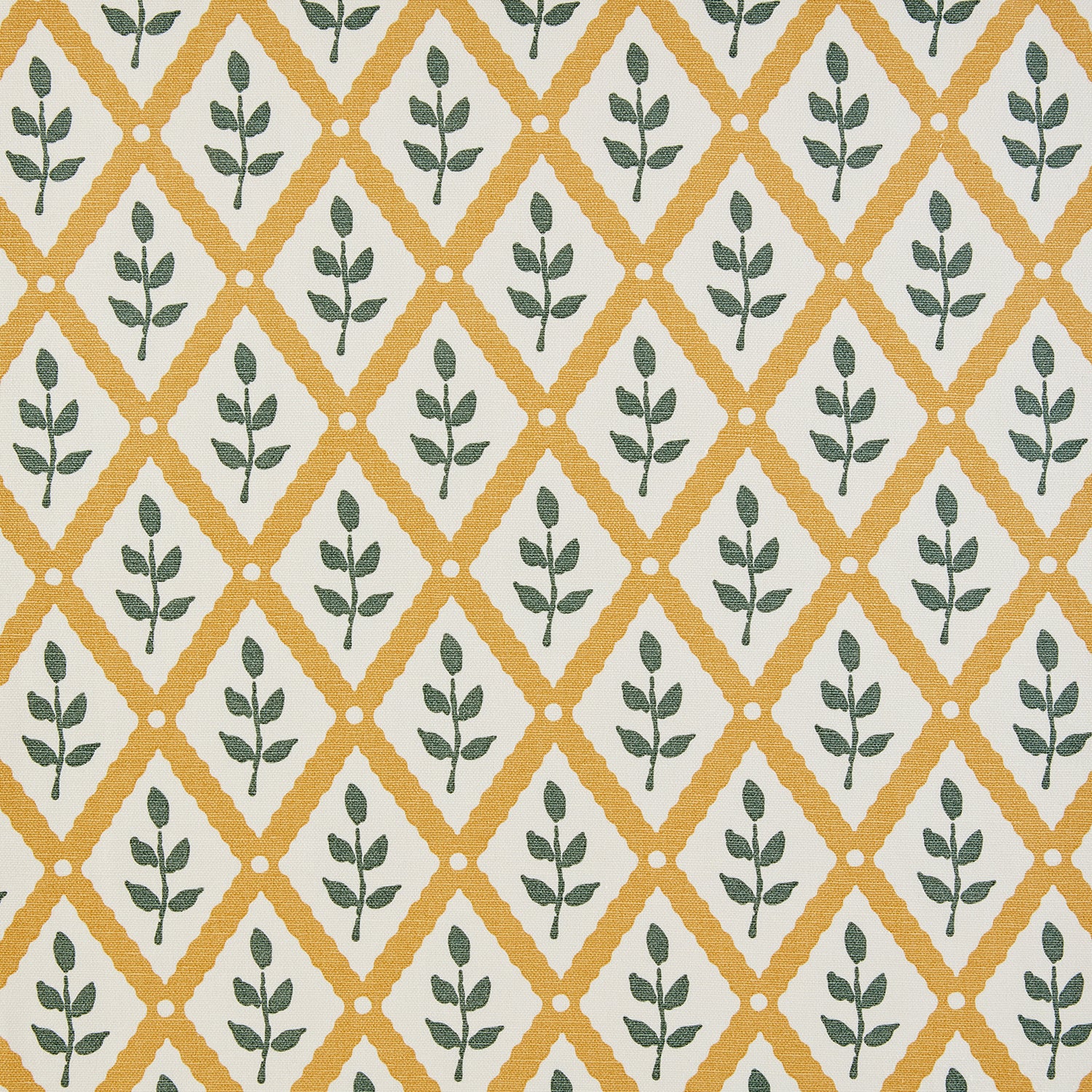 Detail of fabric in a lattice and leaf print in green and yellow on a white field.