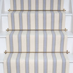 Striped flatweave runner in white and light blue on white staircase