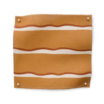 Square fabric swatch in a wide undulating stripe pattern in red and white on a light brown field.
