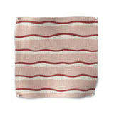 Square fabric swatch in an undulating stripe pattern in red and white on a pink field.