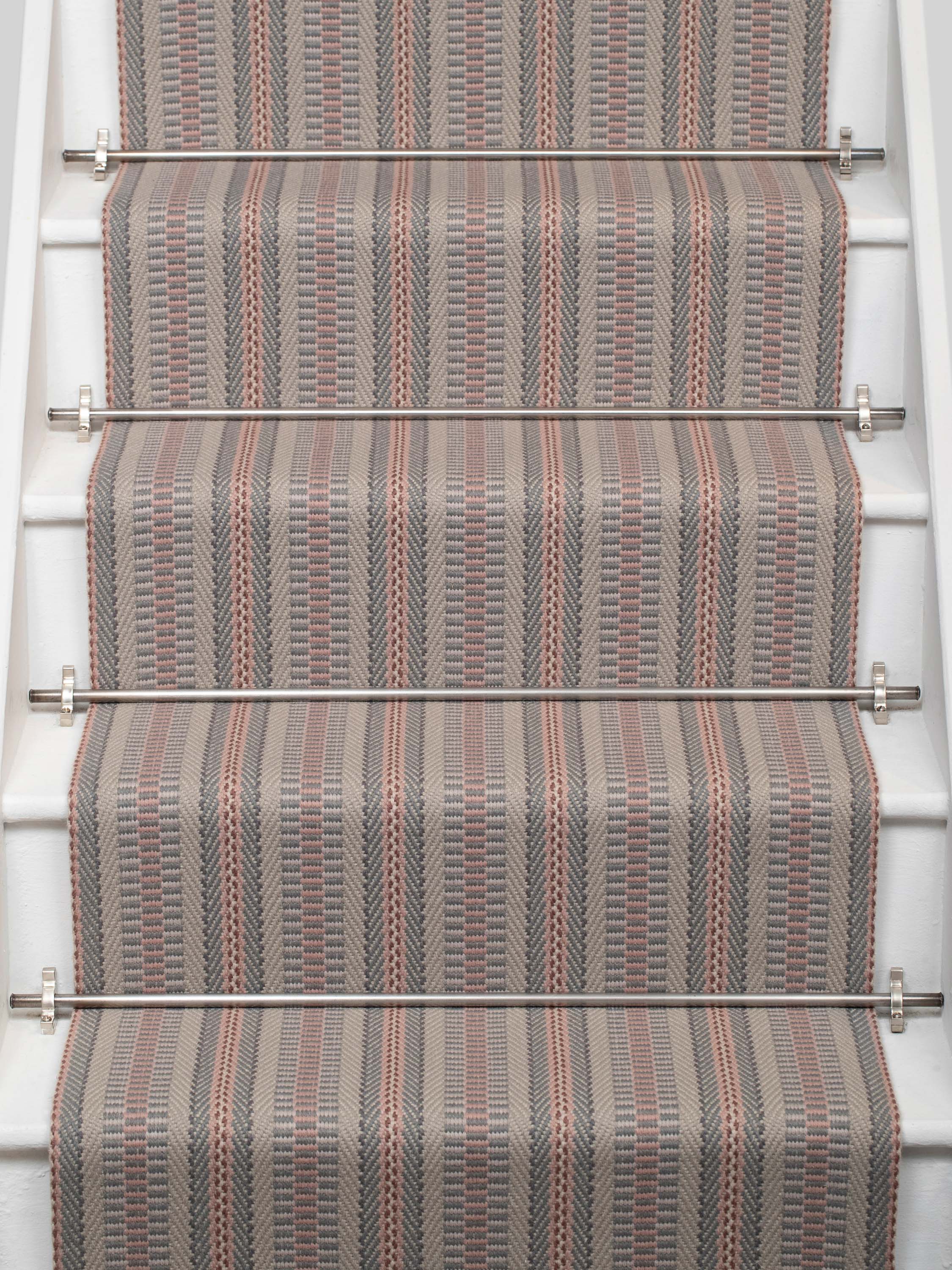 Striped flatweave runner in grey and pink on white staircase