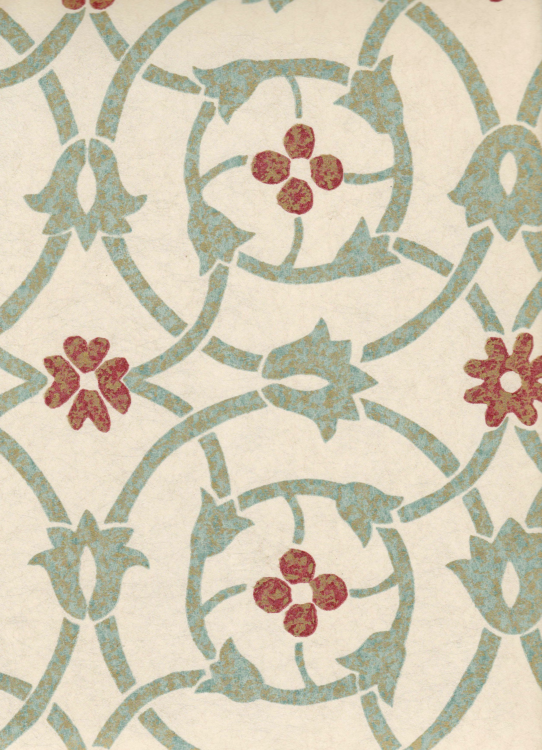 Detail of wallpaper in a floral lattice print in mottled blue, red and tan on a cream field.