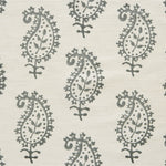 Detail of fabric in a repeating paisley print in gray on a cream field.