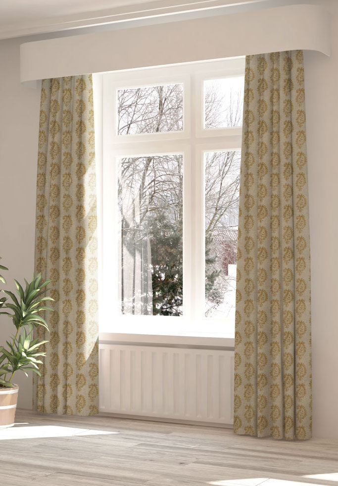 A large, sunny window with long curtains in a paisley print on a cream field.