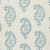 Detail of fabric in a repeating paisley print in light blue on a cream field.