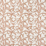 Detail of fabric in an abstract floral print in dusty rose on a cream field.