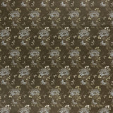 printed linen fabric in a floral and dot pattern in beige and white on a brown field.