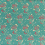 printed linen fabric in a floral and dot pattern in red and beige on a turquoise field.