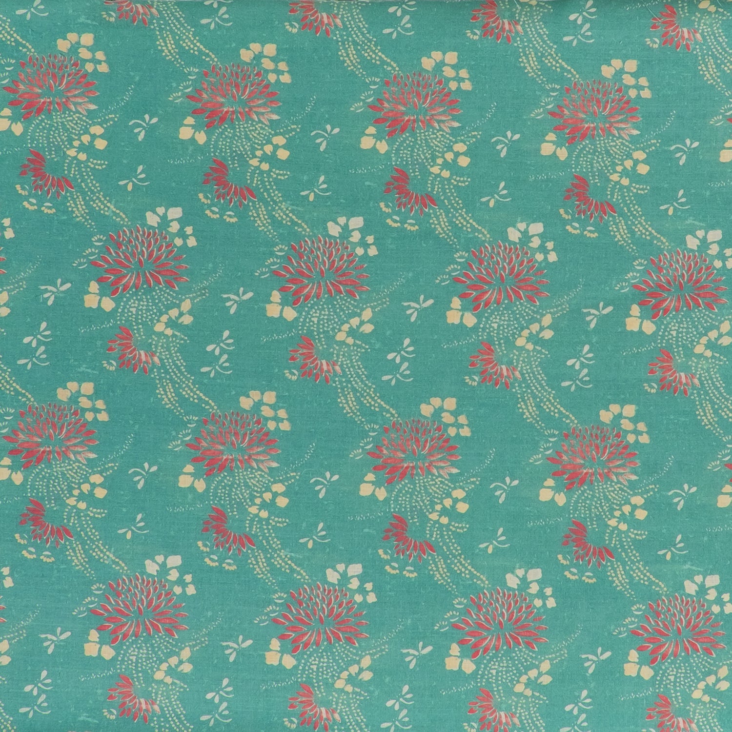 printed linen fabric in a floral and dot pattern in red and beige on a turquoise field.