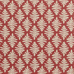 Detail of fabric in a repeating fern leaf print in cream on a dark red field.