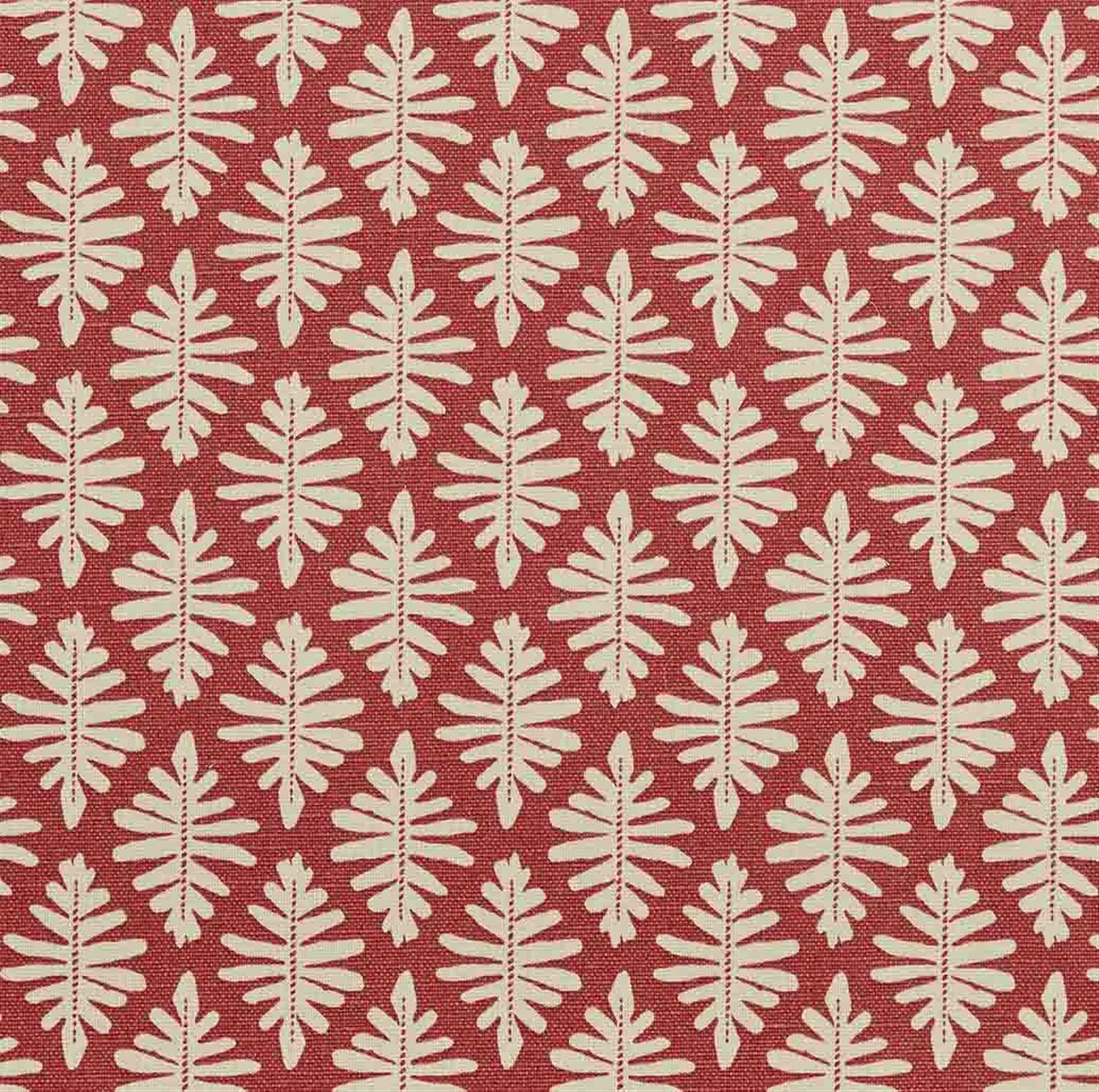 Detail of fabric in a repeating fern leaf print in cream on a dark red field.