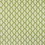 Detail of fabric in a repeating fern leaf print in white on a green field.