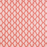 Detail of fabric in a repeating fern leaf print in white on a coral field.