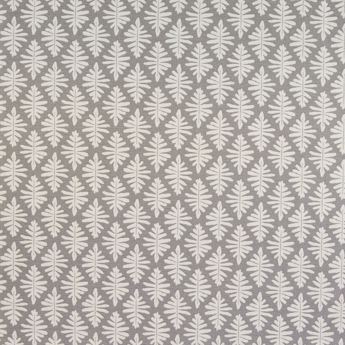 Detail of fabric in a repeating fern leaf print in white on a gray field.