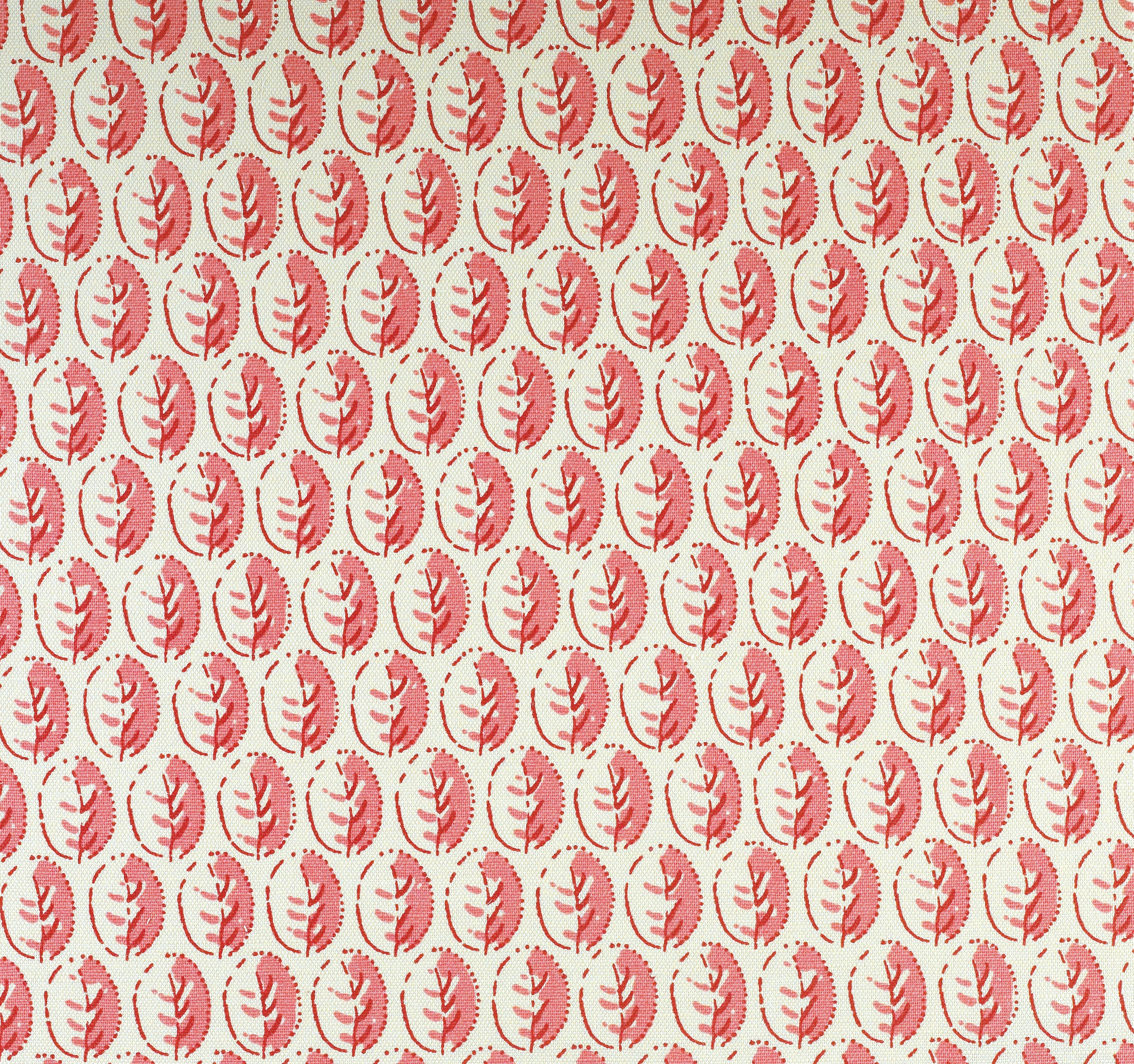 Detail of fabric in a repeating leaf print in pink and red on a cream field.