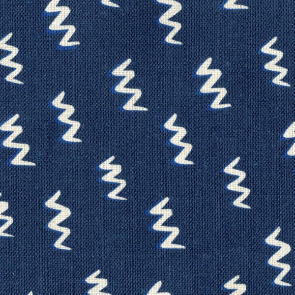 Fabric in a painterly zigzag pattern in white on a navy field.