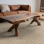 Living room with a wooden coffee table and brown leather sofa.
