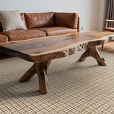 Living room with a wooden coffee table and brown leather sofa.