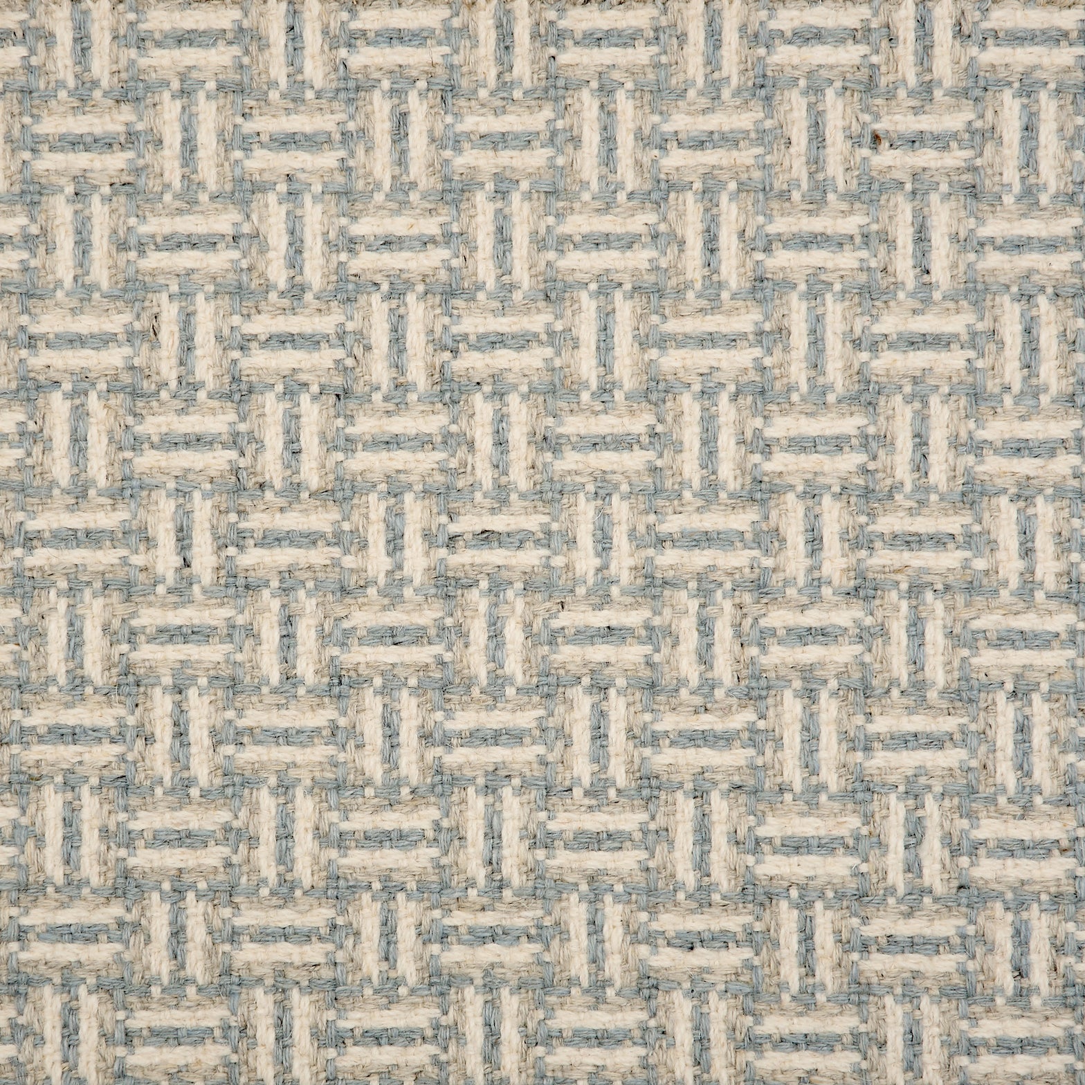 Broadloom carpet with a geometric herringbone design in cream, grey and blue.